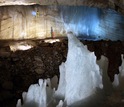 The ice cliff with a member of the research team rappelling down into the 